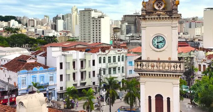 4K drone aerial view of Juiz de Fora City Hall Clock Tower and historic downtown in Minas Gerais, Brazil, with colonial architecture.
