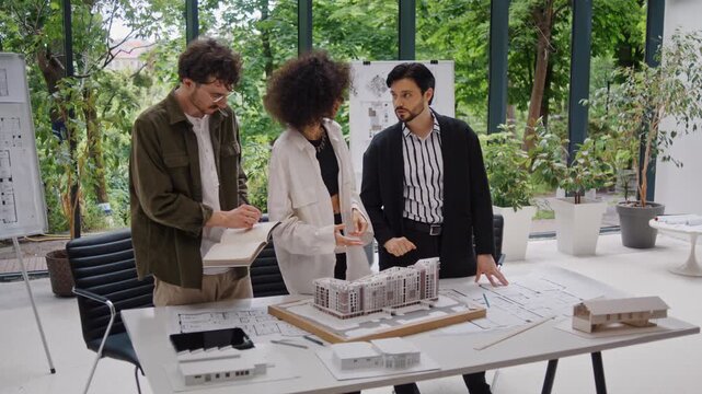 Team studies architectural models of comfortable family homes