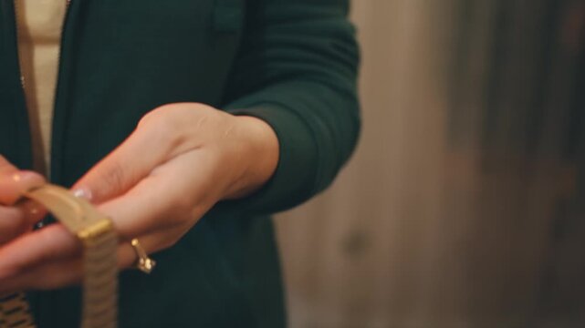 person removes jewellery watch from hands for safety reasons. rules of safety at work. stages of working day preparation at factory. large-scale production manufacturing processing herbs for sale