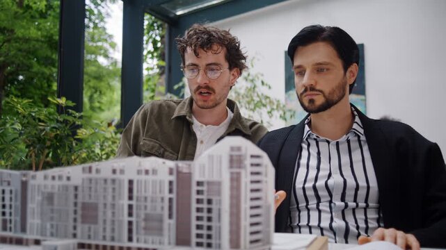 Architect confidently explains residential building concept