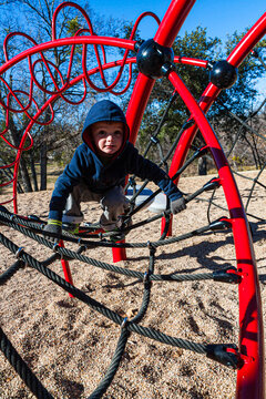 Little Boy Climbing Ropes at Playground, Glen Rose, Texas, USA