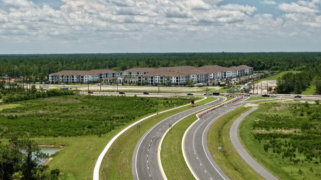 Aerial view of the intersection of International Golf Parkway and Saint Johns Parkway with surrounding apartment complexes in World Golf Village, Florida, United States.