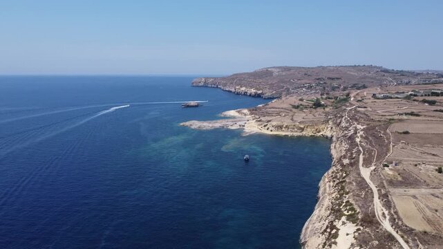 Xatt L-Ahmar, Gozo, Malta. Salt apns. serene aerial view of rocky coastline with sandy beaches and calm waters in natural setting for travel and vacation purposes. stationery perspective from above