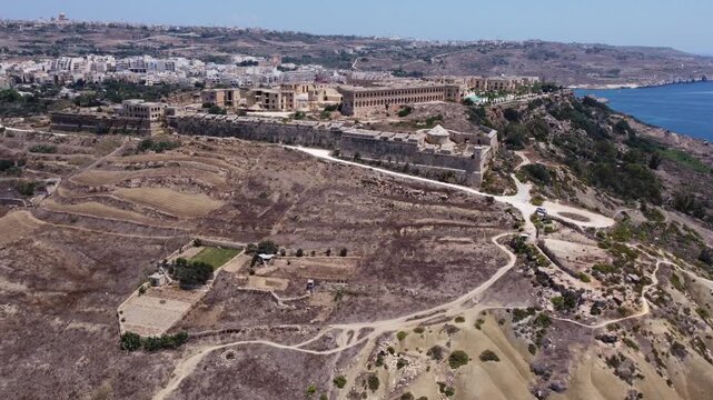 Fort Chambray, Gozo, Malta, aerial view. Approaching from the Xatt L-Ahmar salt pans. High quality 4k footage