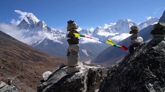 SLOW MOTION of Holy Buddhist prayer multicolored flags with mantras flapping in strong wind, valley view and Ama Dablam 6812m peak. Everest Base Camp trekking route near Dughla 4620m.