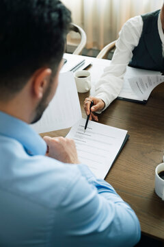 Female salesperson explaining important points of agreement to client during meeting