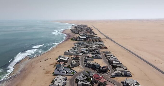 Aerial jib shot of Langstrand, a beach resort town between Swakopmund and Walvis Bay in the Namib Desert, Namibia.