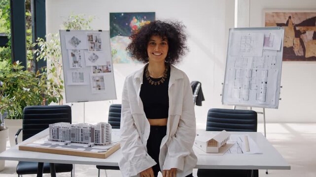 African American woman architect designer sits on office desk