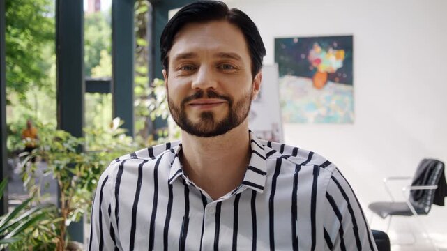 Young designer with three day stubble radiates self assurance