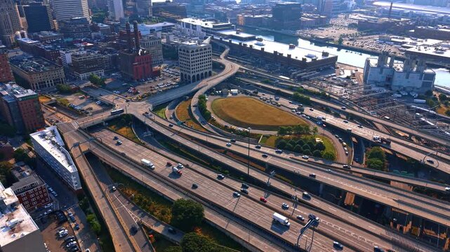 Traffic in modern downtown of Boston, Massachusetts, USA at sunset. Roads and trestles of the city from drone.