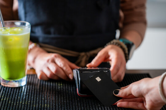 Woman Bartender Taking Card Payment
