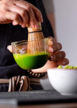 Woman Bartender Mixing Matcha Tea Whisking
