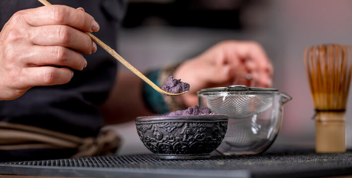 Woman Pouring Blue Matcha Into Sifter