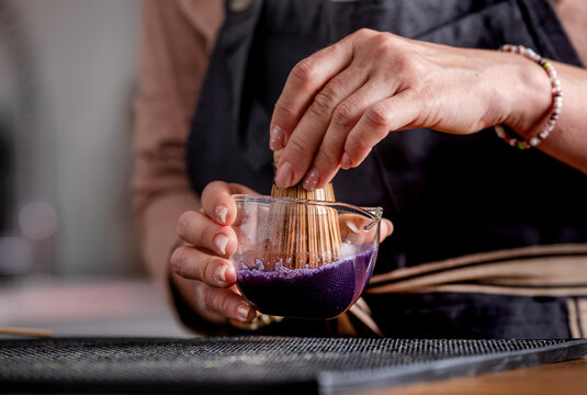 Woman Stirring Blue Matcha Tea
