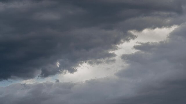 Thick, dark clouds rolling in on the eve of a rainstorm, close-up shots of patches of sky.