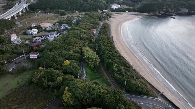 Train Passing Tainohama Beach at Sunrise in Tokushima, Japan
