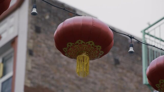 Single Red Lantern with Gold Tassel, Close-Up, Swaying