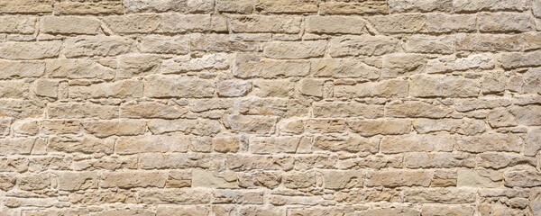 Obraz premium Old limestone rock wall presenting rough texture surface