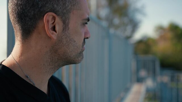 man looks around him suspiciously 