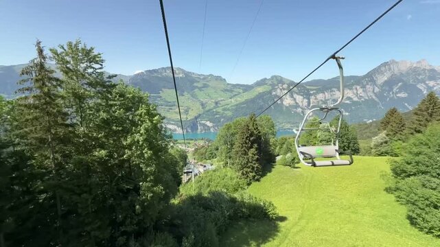 Video Footage of a Chairlift Ride Above Green Alpine Slopes With Lake Walensee Panorama in Switzerland