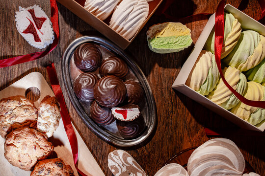 Assorted Handmade Marshmallows, Chocolate Covered Sweets and Homemade Cookies on Rustic Wooden Table