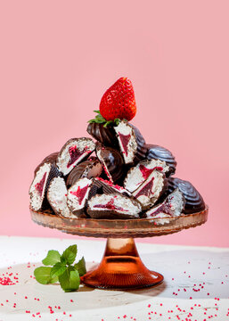 Chocolate Covered Marshmallows with Strawberry Filling and Fresh Strawberries on Pink Background