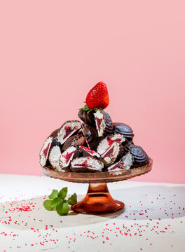 Chocolate Covered Marshmallows with Strawberry Filling and Fresh Strawberries on Pink Background