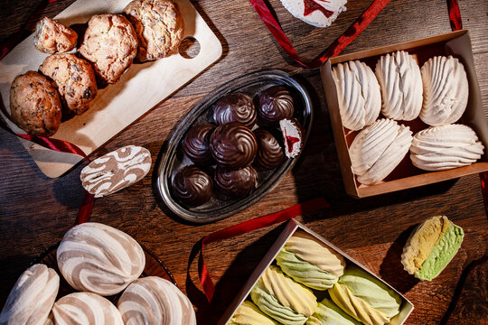 Assorted Handmade Marshmallows, Chocolate Covered Sweets and Homemade Cookies on Rustic Wooden Table