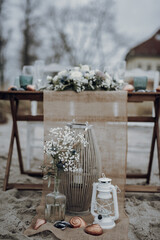 Maritime beach wedding table with burlap runner and lanterns © LeifOliver