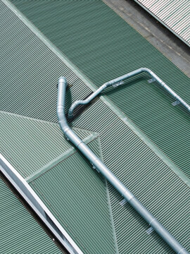 Aerial view of a green corrugated metal roof featuring industrial ventilation ducts in Upmalas, Sigulda Municipality, Latvia.