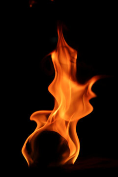 Bright Flame Dancing Gracefully Against a Dark Background