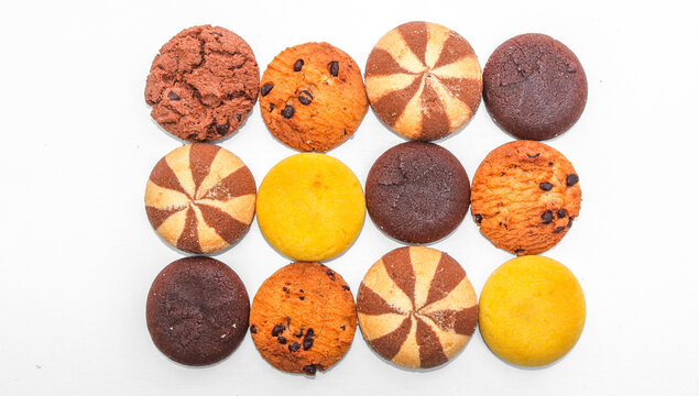 Assorted cookies and biscuits isolated on white background. Collection of sweet baked snacks including chocolate cookies, butter biscuits, crackers and sandwich cookies. 