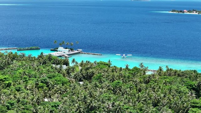 Seaplane floating near tropical Maldives island