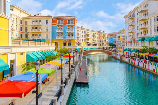 The brightly colored Qanat Quartier in The Pearl Island, Doha, Qatar, a district designed to emulate Venetian architecture with waterways and bridges.