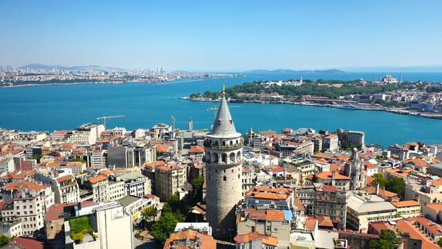 Aerial view of Galata Tower rising above Beyoglu district with Golden Horn, Bosphorus strait and Topkapi Palace peninsula in background, Istanbul