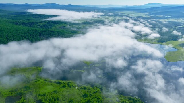 Aerial View of Misty Clouds Over Wetlands and Forests