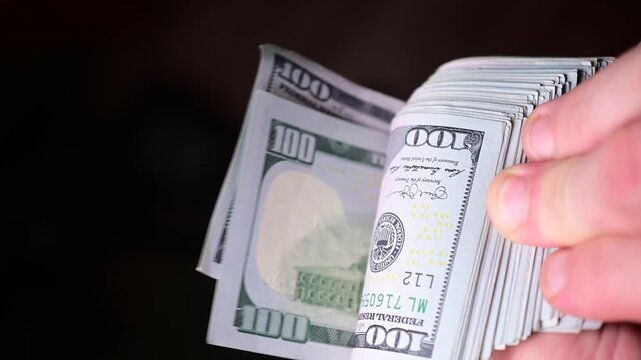 Stock of hundred dollars bills bokeh macro close up, texture, in and out of focus, abstract money finances, studio selective focus real time video