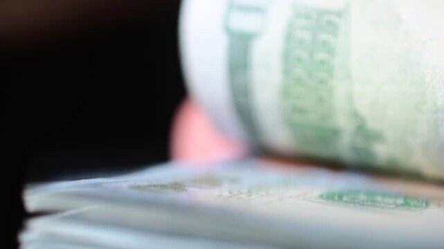 Stock of hundred dollars bills bokeh macro close up, texture, in and out of focus, abstract money finances, studio selective focus real time video