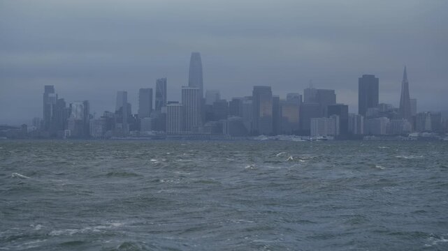 San Francisco Skyline from Bay With Choppy Waves In Dense Fog and Overcast - Wide Shot