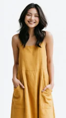 A person in a flowing golden dress stands with arms relaxed and smiling © AS_SleepingPanda