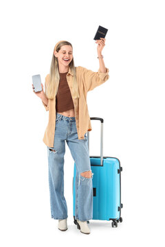Happy young woman holding passport and phone with suitcase