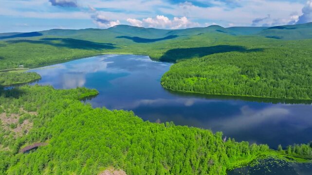 Aerial View of Serene Lake Amidst Lush Green Forests and Mountains