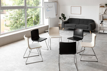 Fototapeta premium Empty support group meeting room with chairs arranged in circle