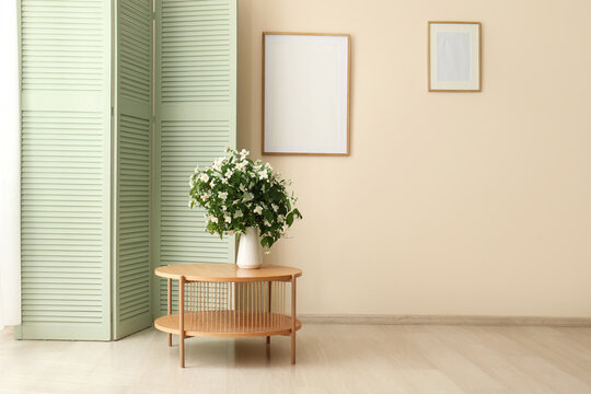 Minimalist interior with wooden table and flower vase