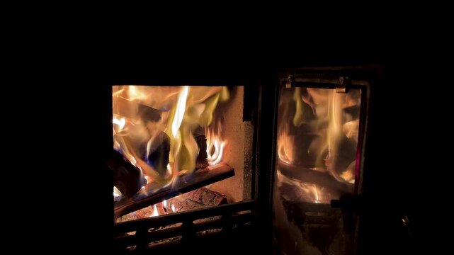 Wood burning wooden stick stove in forest cabin hut darkness in Iran fire flame heater slow burn at night cold freezing rustic tranquil firewood cozy farm Caucasus Armenia canvas tent camping glamping