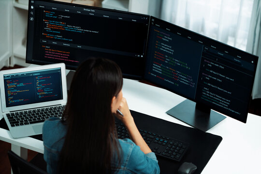 Top view young Asian IT developer creating with typing online information on pc with coding program data of website application, wearing jeans shirt. surround by safety analysis two screen. Stratagem.