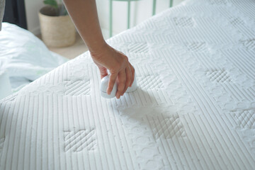 Person cleaning a mattress with a handheld device © Towfiqu Barbhuiya 