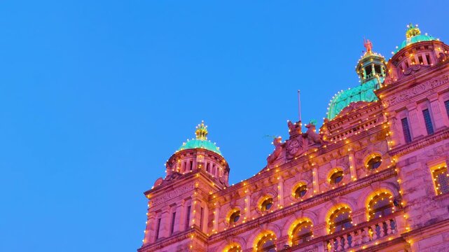Victoria, BC, Canada &ndash; July 2, 2026: Illuminated green copper domes of British Columbia Parliament Buildings