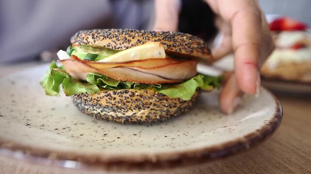 Enjoying a bagel sandwich with fresh ingredients