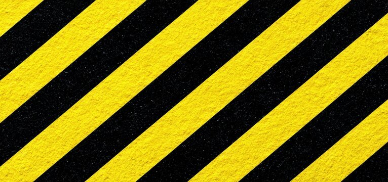 Abstract yellow and black caution stripes pattern industrial hazard warning sign background.